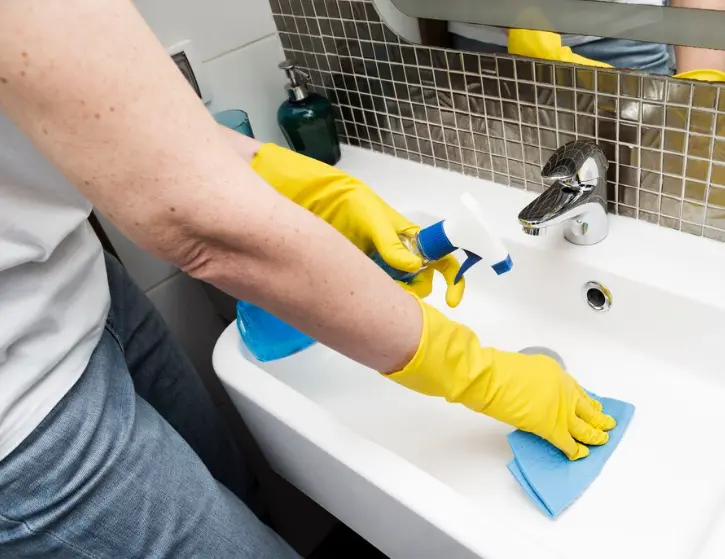 Bathroom cleaning with gloves on