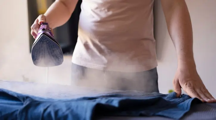 man steaming clothes