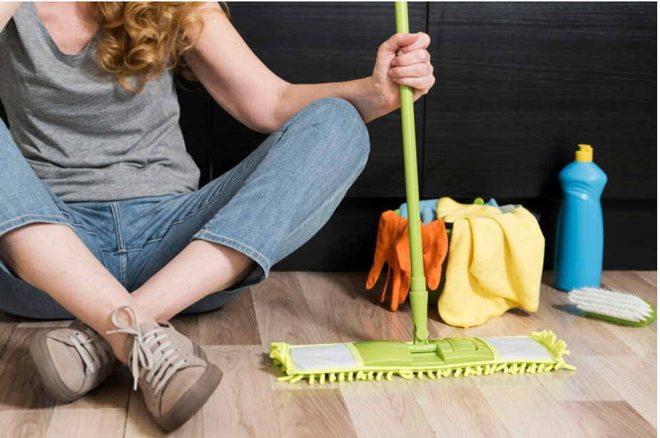 girl sitting to clean laminate floor