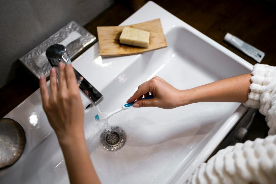 Utility sink cleaning with tooth brush