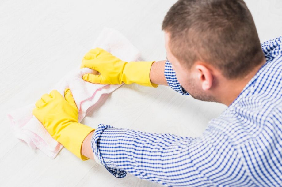 Man cleaning laminated floor