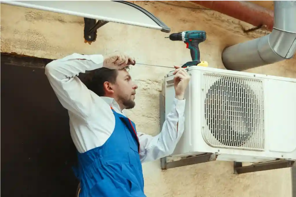 man repairing the ac for leaks