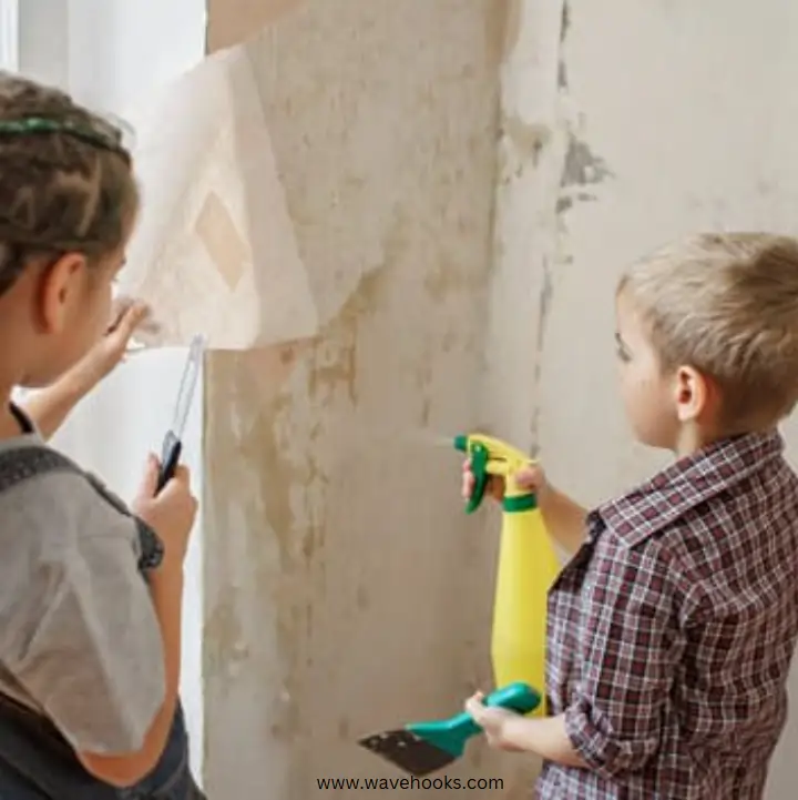 kid removing stickers from wall